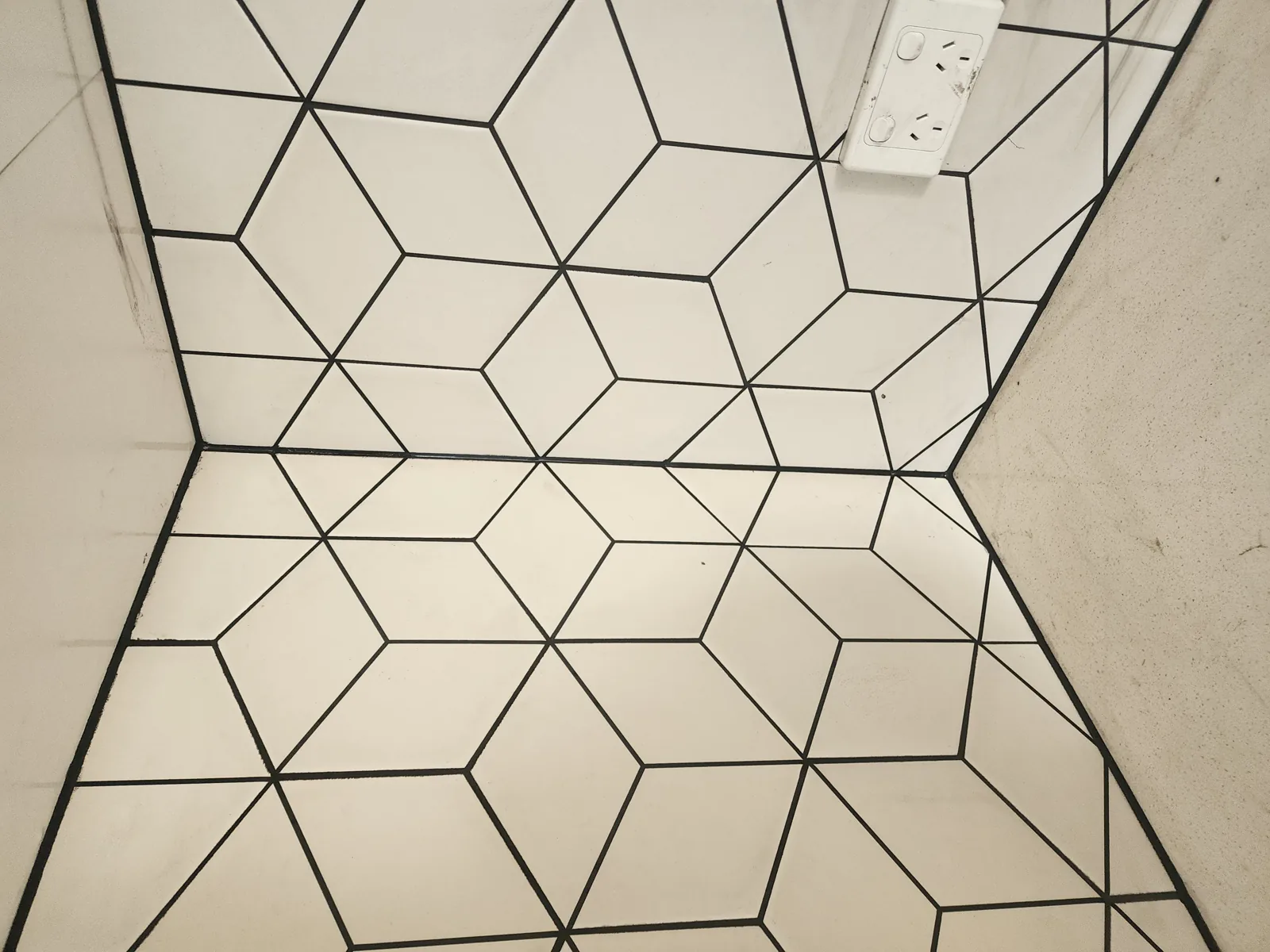 Diamond-pattern tiled kitchen floor with neat black grout lines, Melbourne